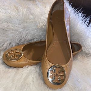 Tori Burch tan flats size 10.5 with huge gold logo at front of shoe